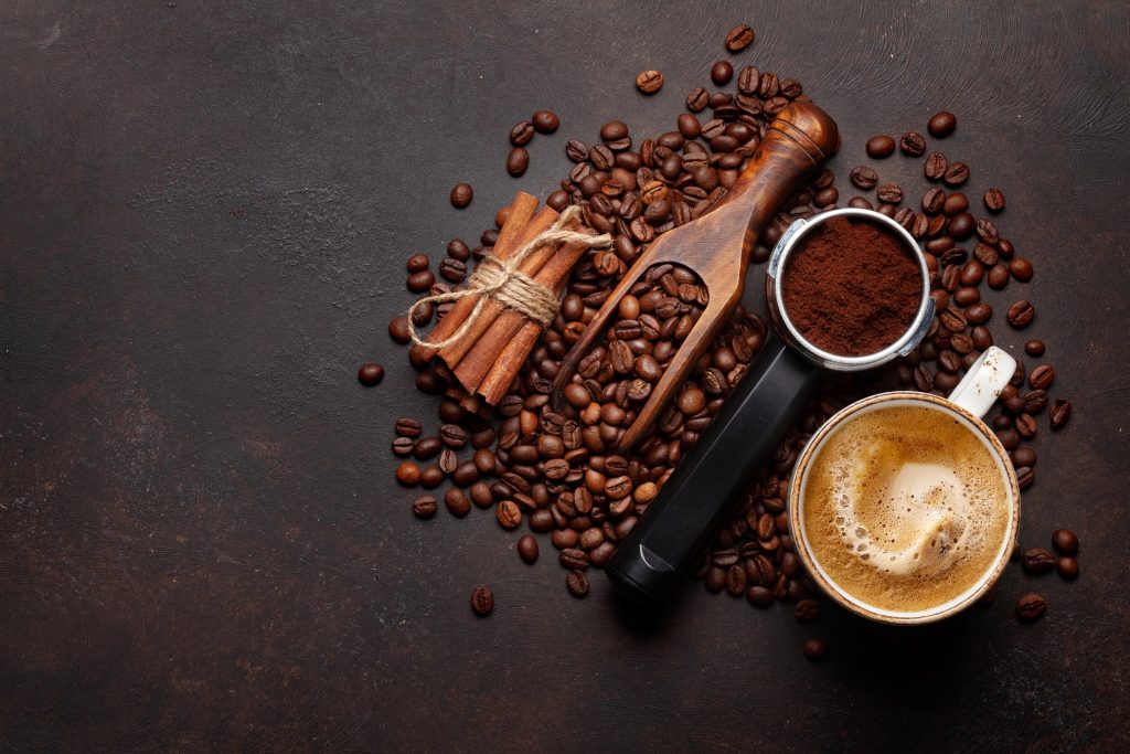 Roasted coffee beans and ground coffee in filter holder