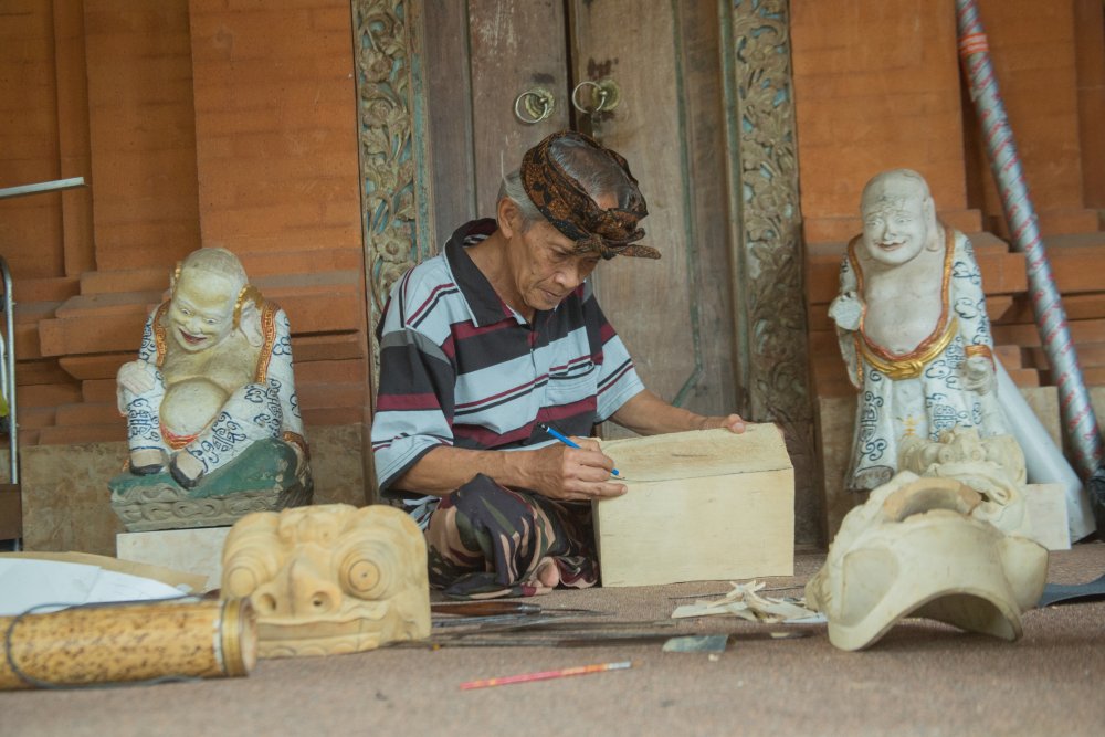 A balinese mask carver sketches his vision onto the wood - Photo by IB Putra Adnyana